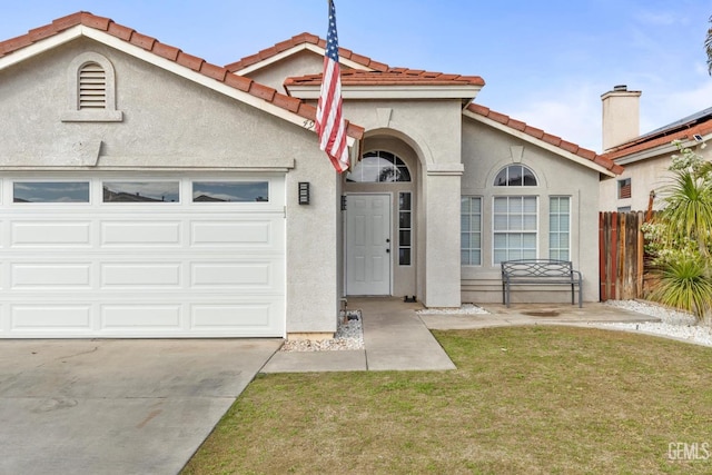 view of front of property with a garage and a front yard