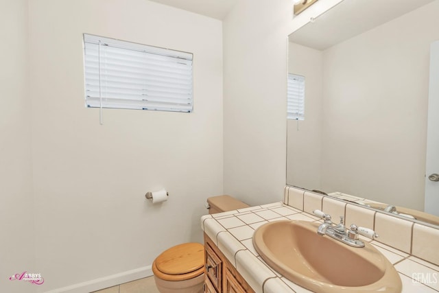 bathroom with toilet, tile patterned flooring, and vanity