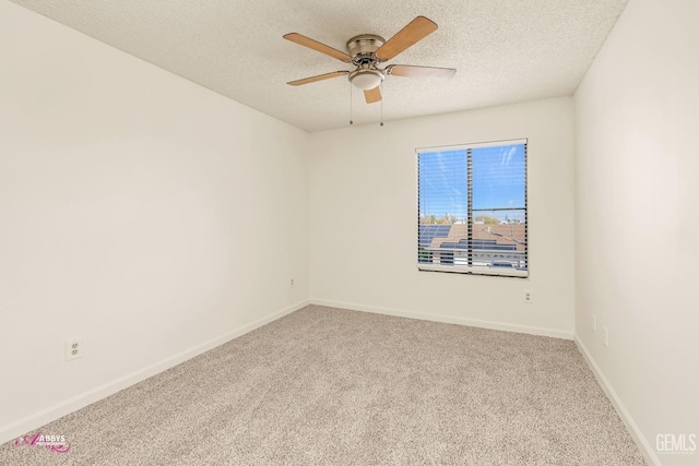 spare room with a textured ceiling, ceiling fan, and carpet