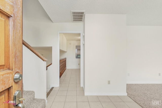 tiled entrance foyer with a textured ceiling