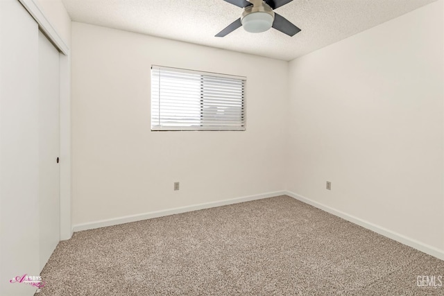 unfurnished bedroom featuring ceiling fan, carpet, a closet, and a textured ceiling