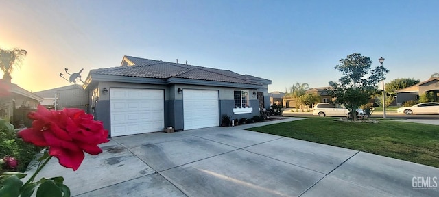 exterior space featuring a yard and a garage