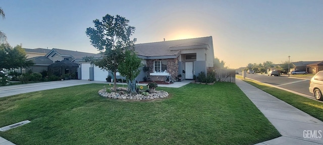 view of front of home featuring a lawn and a garage