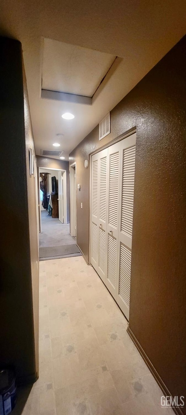 hallway featuring a raised ceiling