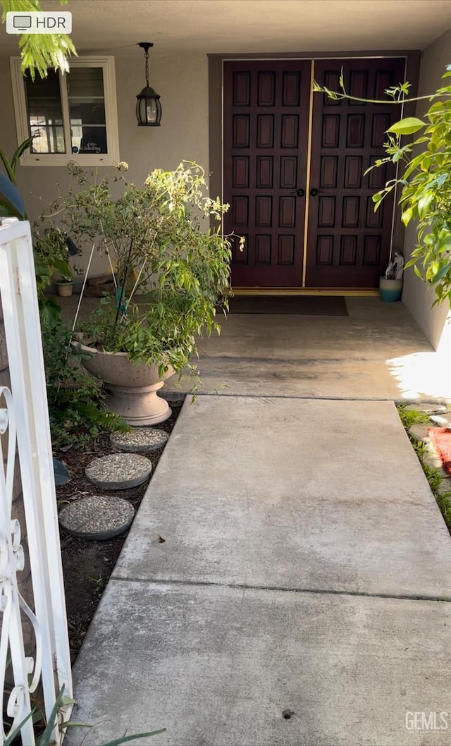 entrance to property featuring stucco siding