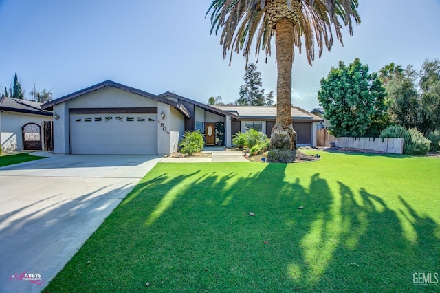 view of front of property featuring a garage and a front yard