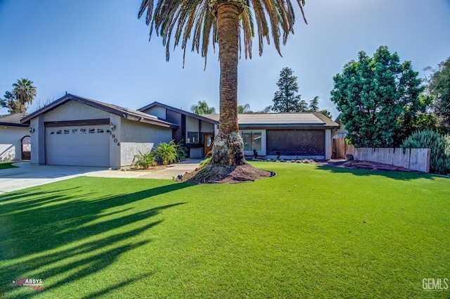 view of front of house featuring a garage and a front lawn