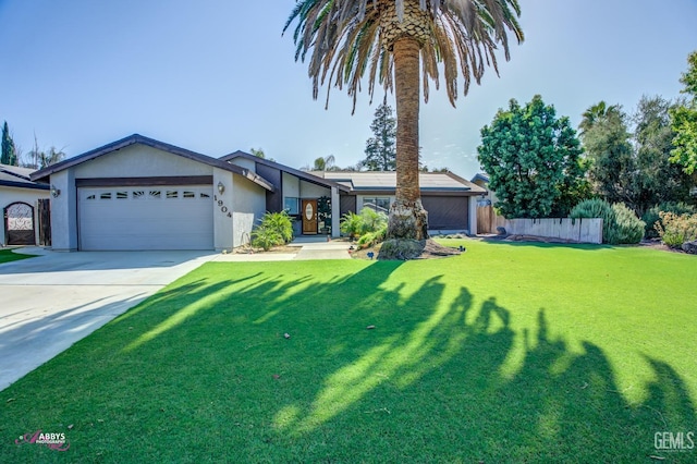 view of front of property featuring a front yard and a garage