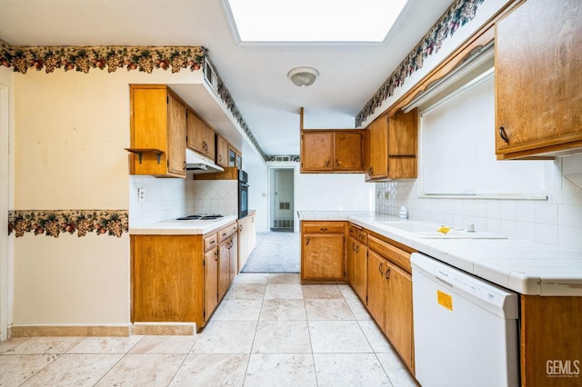 kitchen featuring tile countertops, white appliances, and light tile patterned floors