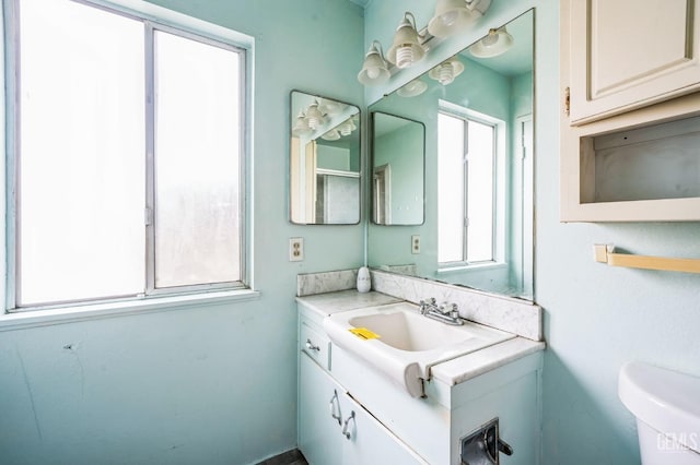 bathroom featuring vanity and toilet