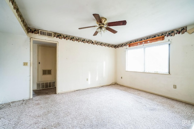 spare room featuring carpet floors and ceiling fan