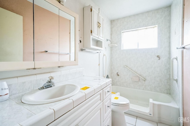 bathroom featuring tile patterned flooring, vanity, tiled shower, and toilet