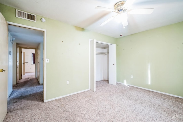 unfurnished bedroom with light carpet, a closet, and ceiling fan