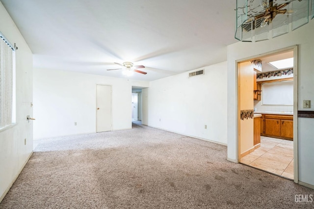 carpeted empty room featuring ceiling fan