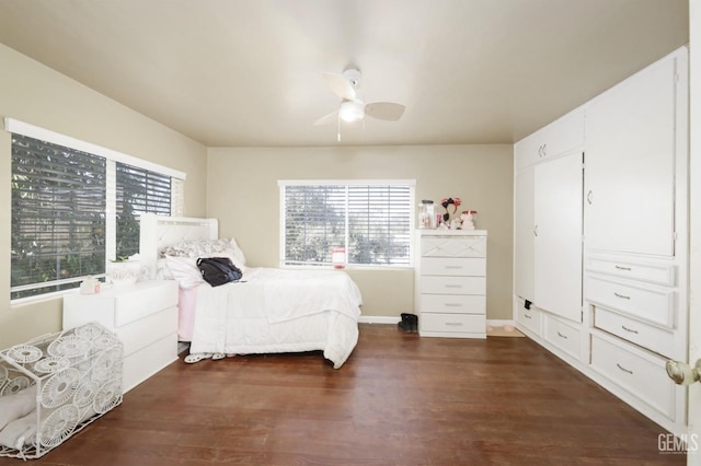 bedroom with multiple windows, ceiling fan, and dark hardwood / wood-style flooring