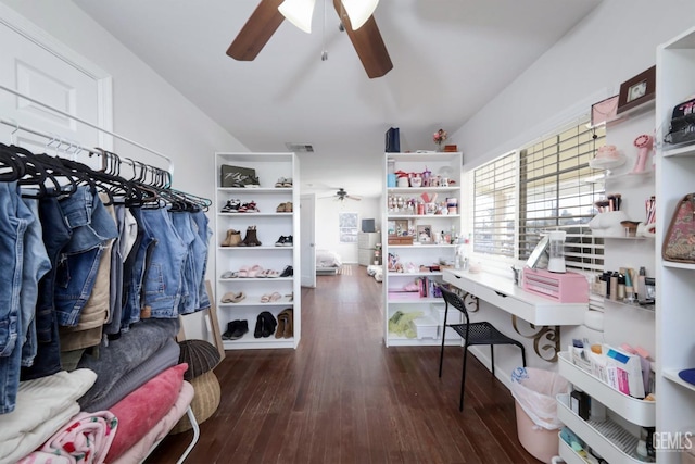 spacious closet with dark hardwood / wood-style floors and ceiling fan