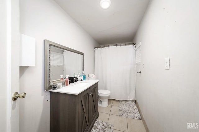 bathroom with tile patterned floors, vanity, toilet, and walk in shower