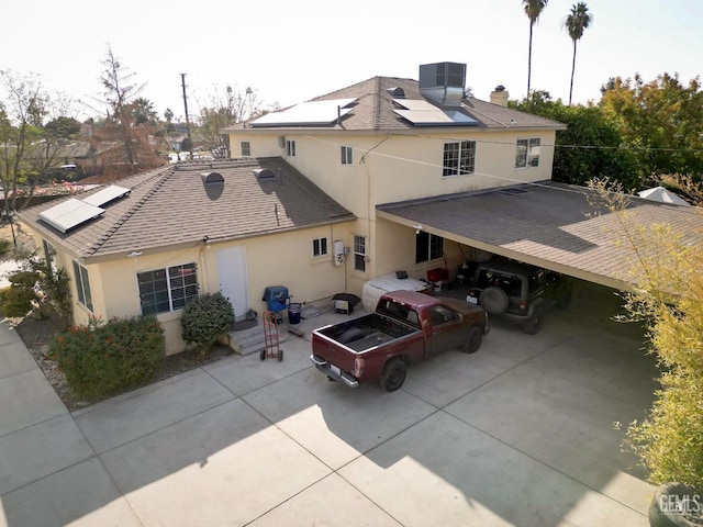 view of front facade with central AC unit and solar panels