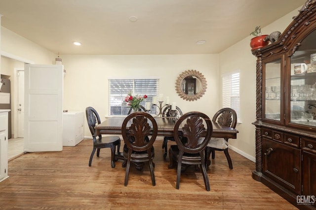 dining space featuring a wealth of natural light and light hardwood / wood-style floors