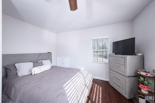 bedroom with ceiling fan and dark hardwood / wood-style floors