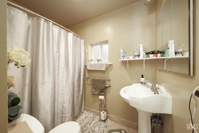 bathroom featuring tile patterned floors and toilet