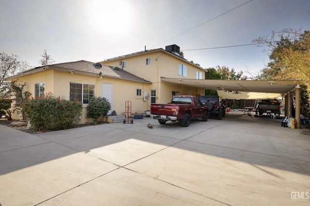 view of side of home featuring a carport and cooling unit