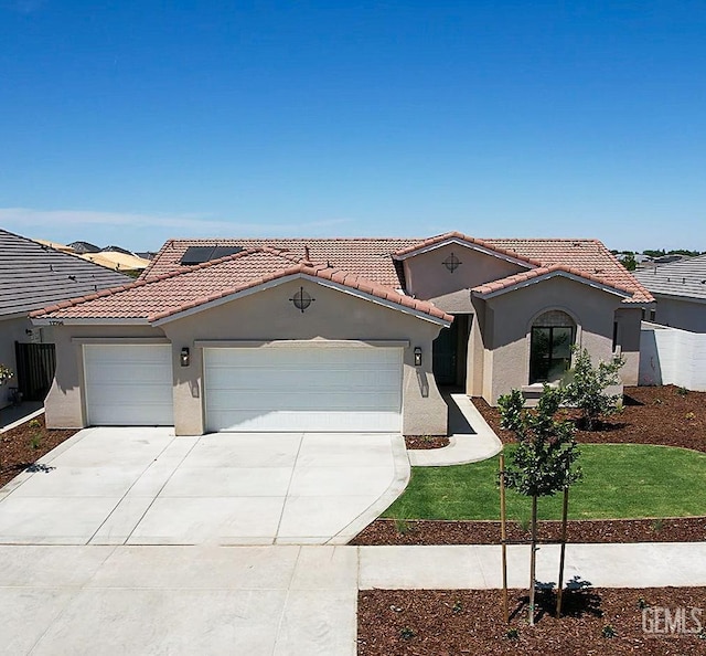12706 Kinnick Ct, Bakersfield, CA 93311 - mediterranean / spanish house featuring a garage, stucco siding, driveway, and a tile roof