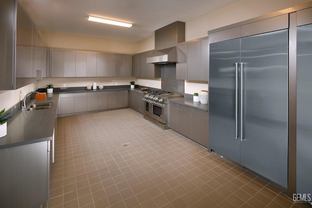 12706 Kinnick Ct, Bakersfield, CA 93311 - kitchen with high end appliances, dark countertops, a sink, and light tile patterned floors