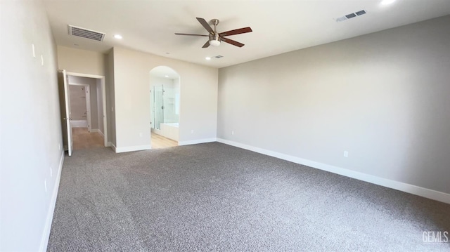 unfurnished bedroom with baseboards, visible vents, arched walkways, and recessed lighting