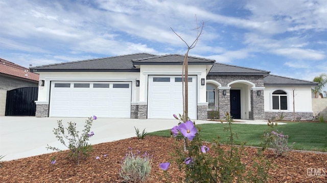 view of front facade featuring concrete driveway, a front lawn, an attached garage, and stucco siding