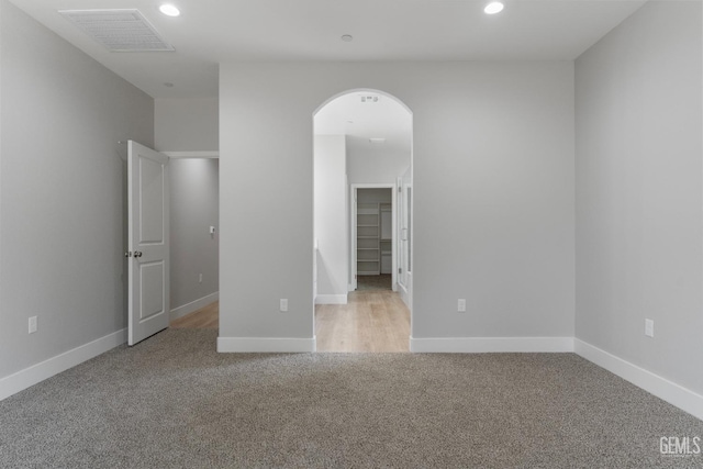 914 Tomboy Ct, Shafter, CA 93263 - spare room with visible vents, arched walkways, recessed lighting, and light colored carpet