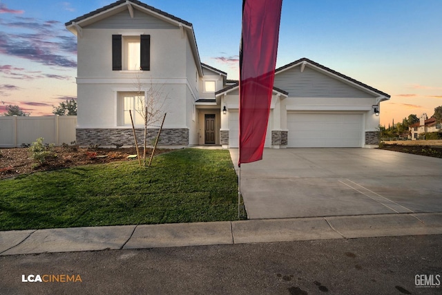 view of front of house featuring driveway, stone siding, and stucco siding