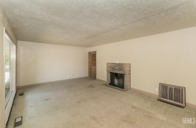 unfurnished living room featuring visible vents, baseboards, carpet floors, and a fireplace