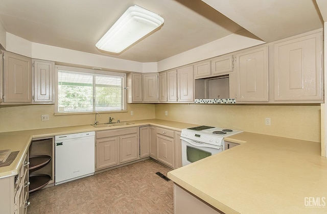 kitchen with visible vents, white appliances, light floors, light countertops, and a sink