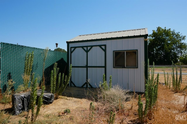 view of shed with fence
