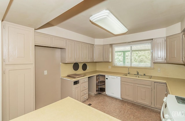 kitchen featuring parquet flooring, range, dishwasher, a sink, and light countertops