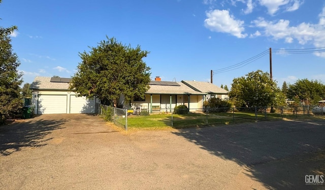 view of front of home with solar panels and a garage