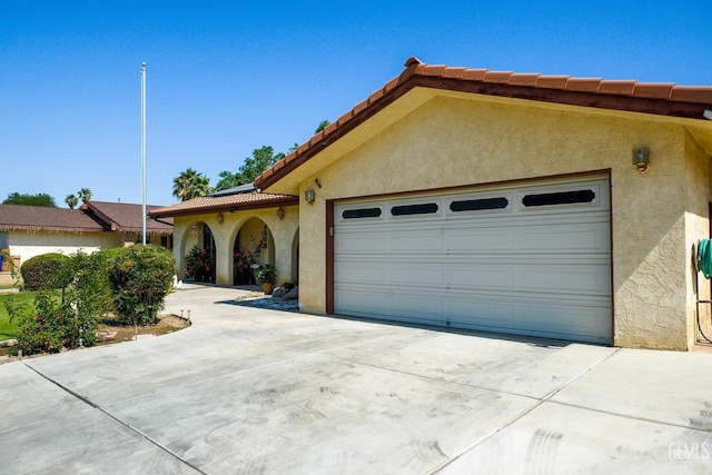 4508 Glengary Pl, Bakersfield, CA 93313 - view of front facade with concrete driveway, a tiled roof, stucco siding, and a garage