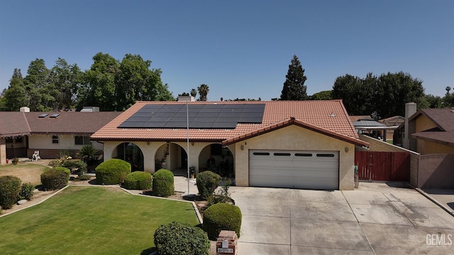 4508 Glengary Pl, Bakersfield, CA 93313 - mediterranean / spanish-style house featuring a tile roof, solar panels, concrete driveway, a garage, and a chimney