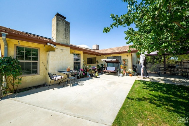 4508 Glengary Pl, Bakersfield, CA 93313 - rear view of property featuring a chimney, stucco siding, a patio area, and a tile roof