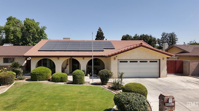 4508 Glengary Pl, Bakersfield, CA 93313 - mediterranean / spanish house featuring stucco siding, a garage, driveway, a tiled roof, and solar panels