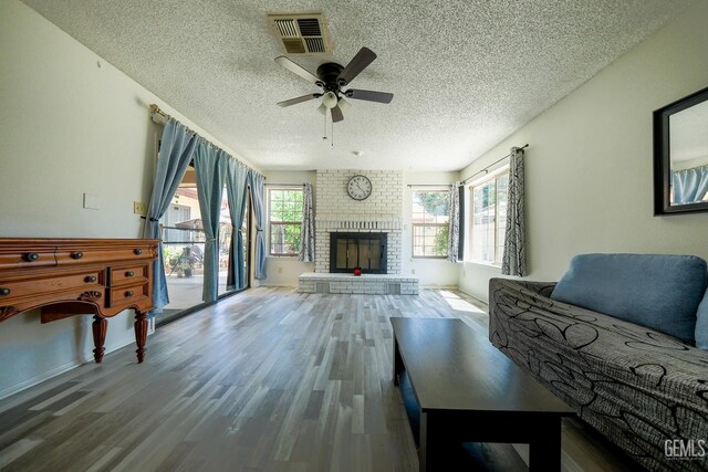 4508 Glengary Pl, Bakersfield, CA 93313 - living area featuring a textured ceiling, wood finished floors, a ceiling fan, and a fireplace