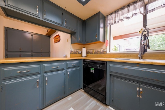 4508 Glengary Pl, Bakersfield, CA 93313 - kitchen with black dishwasher, a sink, light countertops, and blue cabinetry