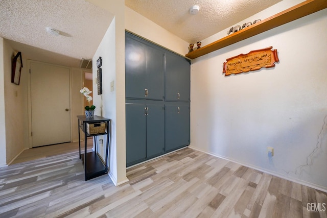 4508 Glengary Pl, Bakersfield, CA 93313 - corridor with a textured ceiling, light wood finished floors, and baseboards