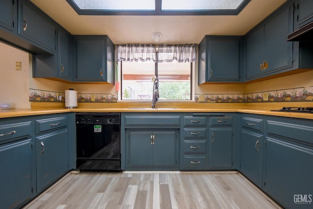 4508 Glengary Pl, Bakersfield, CA 93313 - kitchen with black appliances, a sink, light countertops, blue cabinetry, and under cabinet range hood