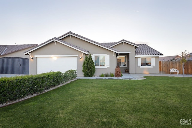 ranch-style house with a tile roof, stucco siding, fence, a garage, and a front lawn