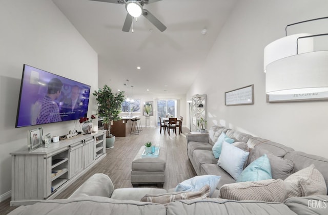 living area featuring high vaulted ceiling, wood finished floors, a ceiling fan, and recessed lighting