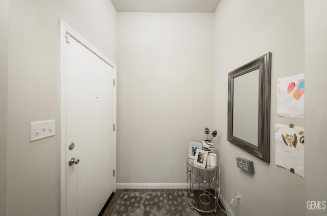 laundry area featuring baseboards