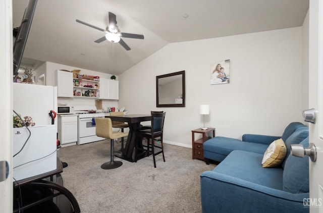 dining room featuring vaulted ceiling, carpet flooring, a ceiling fan, and baseboards