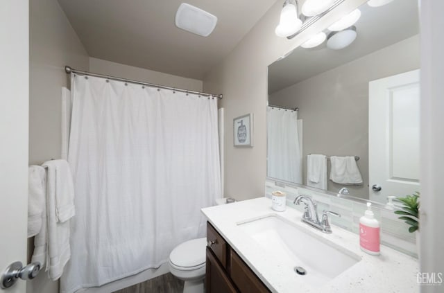 bathroom featuring toilet, curtained shower, a chandelier, and vanity